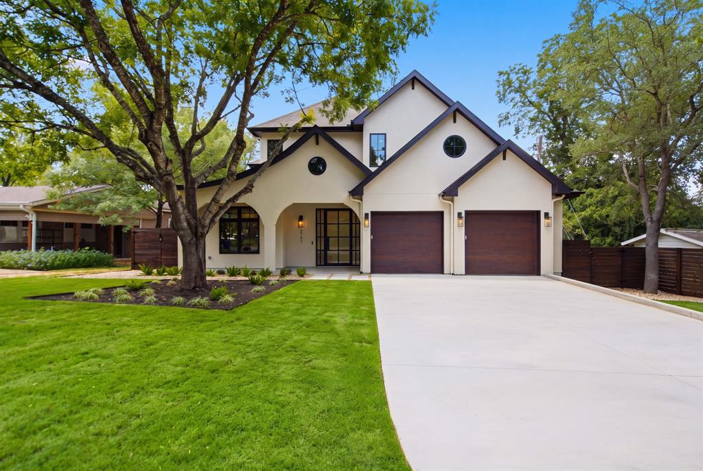 New construction home in Allandale with a two-story stucco exterior and dark wood accents