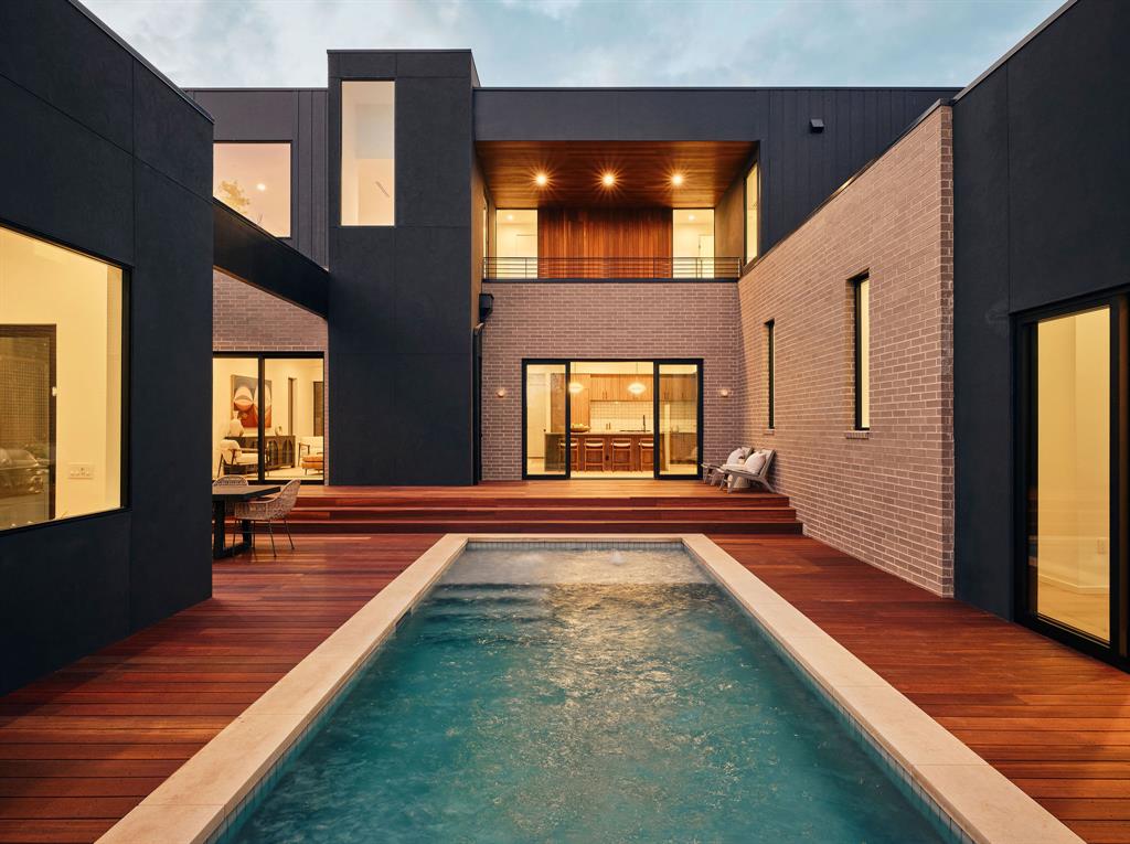 New construction home in Allandale with a modern exterior, courtyard, and lap pool
